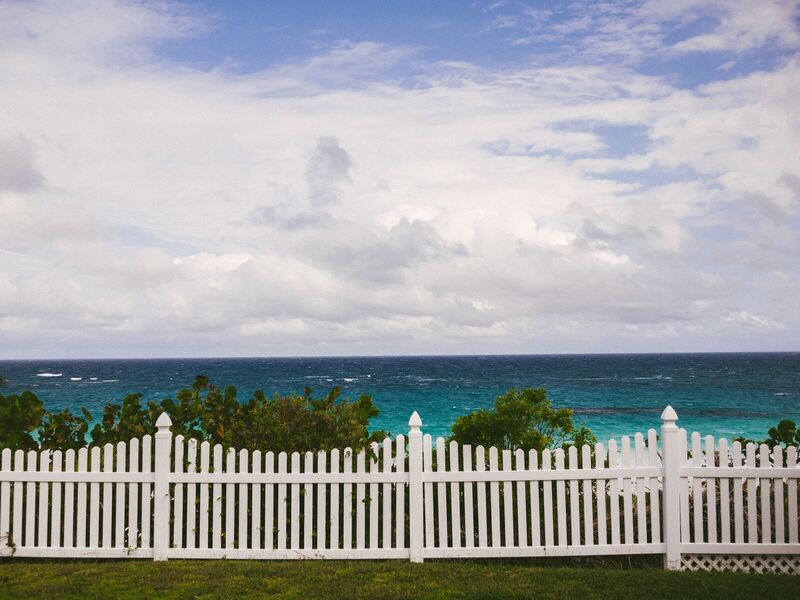 White vinyl scalloped picket fence overlooking the ocean